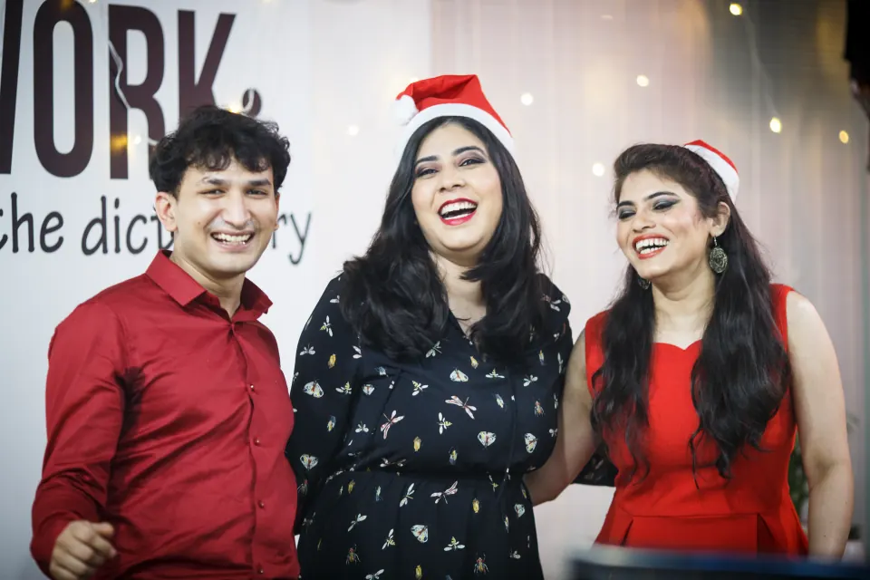 Three colleagues celebrating Christmas