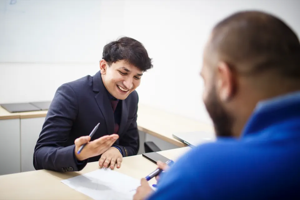 Two colleagues at a desk meeting