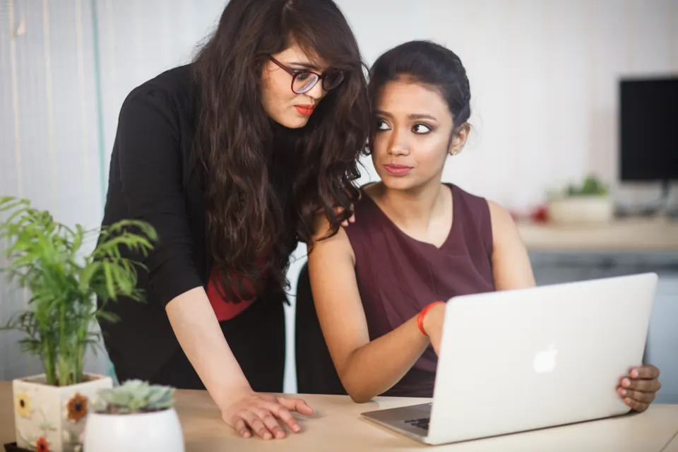 Two colleagues working together at a laptop