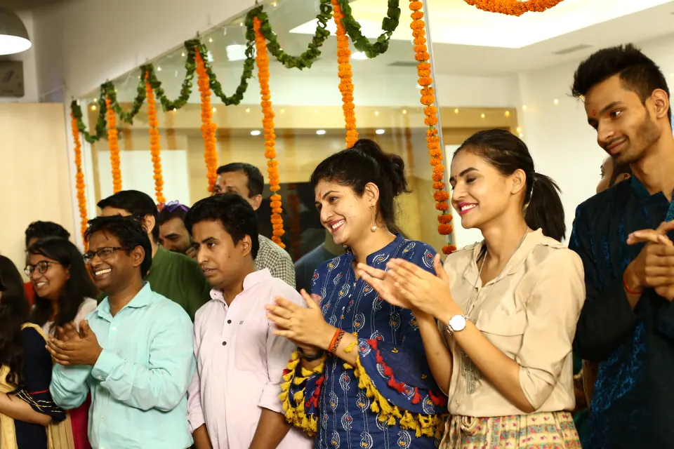 Colleagues clapping along at a festive celebration