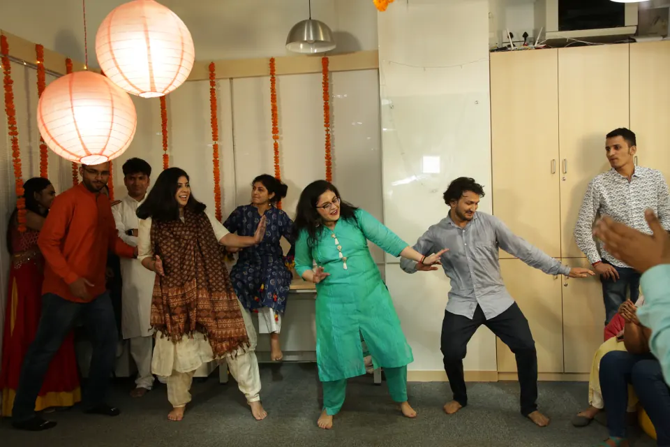 Colleagues dancing together at an office celebration