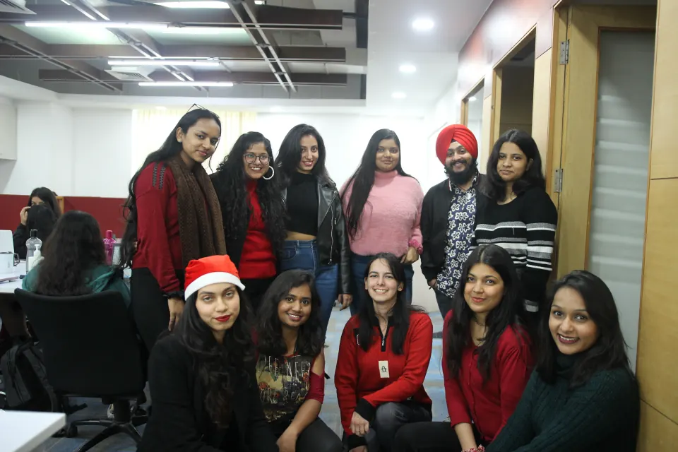 A Christmas group photo in Santa hats