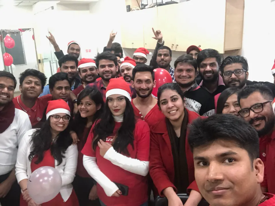 A big Christmas group selfie in Santa hats