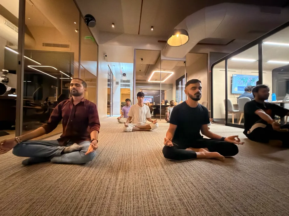 Colleagues meditating during a yoga session