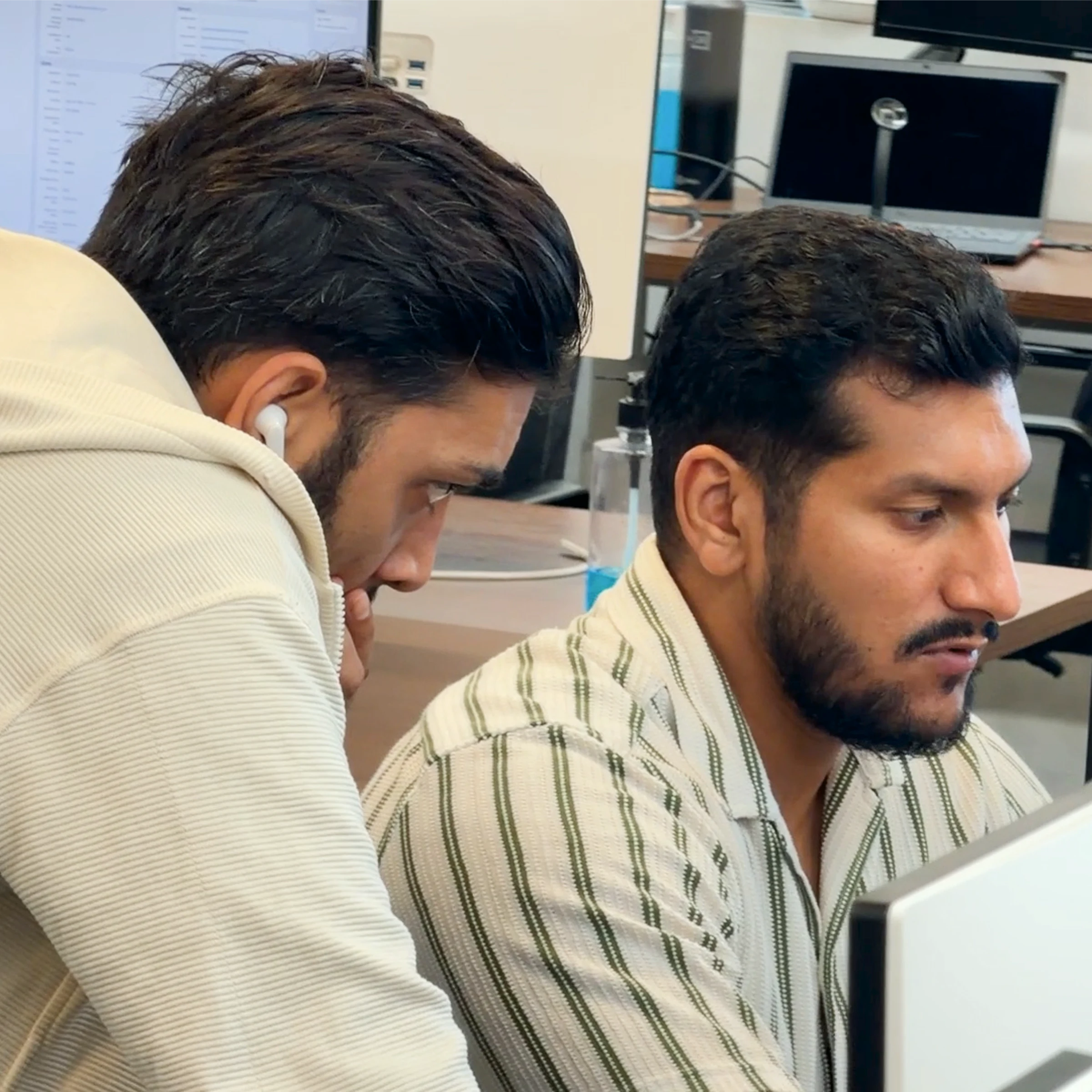 Two MoreTasks colleagues going over work together on one screen